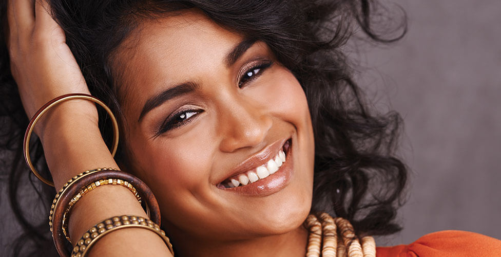 A patient smiling broadly, showing the result of cosmetic dental work